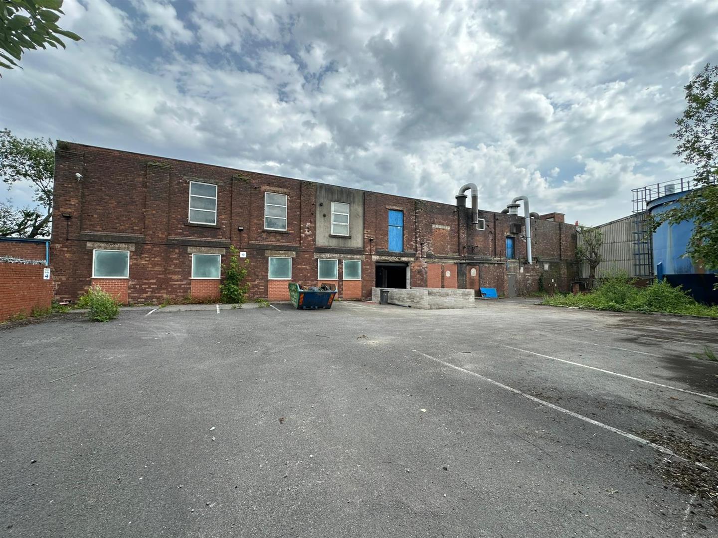 The terrace of brick units and yard at Royal Oak Works, Swinton